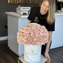 Large bouquet of pale pink roses in a white hatbox