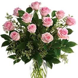 Pink roses arranged in a clear glass vase
