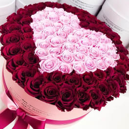 Heart-shaped box filled with pink and burgundy roses