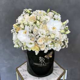 White and cream bouquet in a black hat box with gold butterfly accents