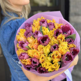 Bouquet of purple and yellow fringed tulips wrapped in pink paper