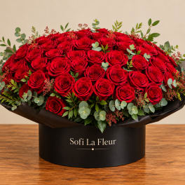 Large bouquet of red roses in a black round box