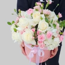 Pink and white bouquet in a round pink box with ribbon