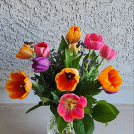 Colorful tulip bouquet in a clear glass vase