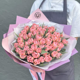Large bouquet of pink tulips wrapped in pink and white paper