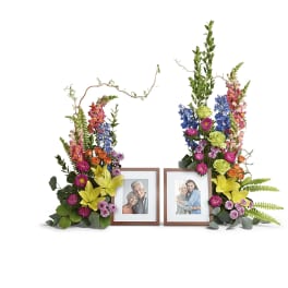 Two floral sprays framing two photo frames