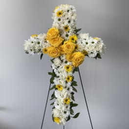 White and yellow floral cross on a stand