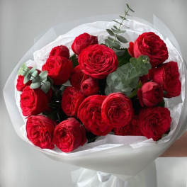 Bouquet of red roses wrapped in white paper