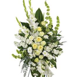 White and pale yellow floral standing spray on an easel