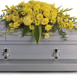 Yellow floral spray on a silver casket