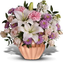 Pink and white floral arrangement in a peach vase