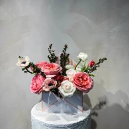 Pink and white roses with anemones in a square box