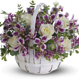 White basket of white roses and purple alstroemeria