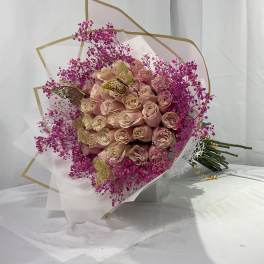 Bouquet of blush roses with bright pink filler flowers