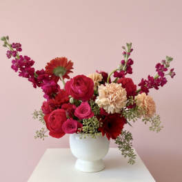 Pink and red mixed bouquet in a white vase