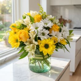 Yellow and white mixed bouquet in a glass vase