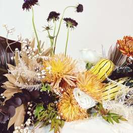 Autumn floral arrangement with yellow chrysanthemums and white roses