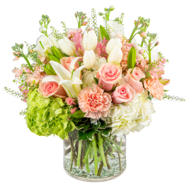 Pink roses and white lilies in a clear glass vase