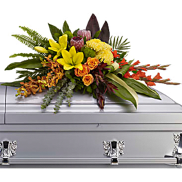 Tropical floral spray on a silver casket
