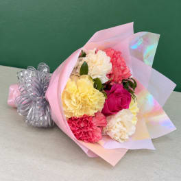 Bouquet of multicolored carnations wrapped in pink paper