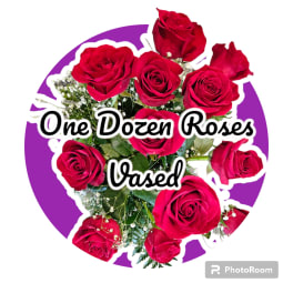 Dozen red roses arranged in a vase with baby's breath