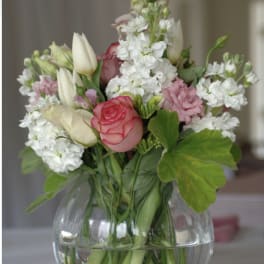 Bouquet of pink and white flowers in a clear glass vase