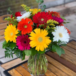 Colorful gerbera daisy bouquet in a clear glass vase