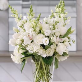 White floral arrangement in a clear glass vase