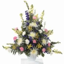 Tall mixed flower arrangement in a white vase