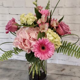 Pink and cream mixed bouquet in a clear glass vase
