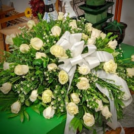 Large white rose arrangement with a satin ribbon bow