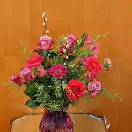 Pink mixed flower arrangement in a glass vase