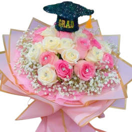 Pink and white rose bouquet with a graduation cap topper