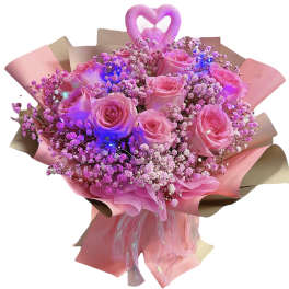 Pink rose bouquet with baby’s breath and a heart topper