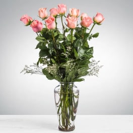 Pink roses arranged in a clear glass vase