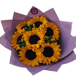 Bouquet of sunflowers wrapped in purple paper