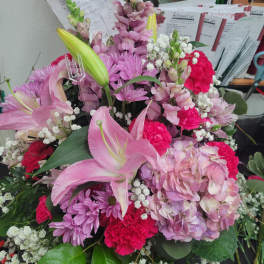 Pink lilies, hydrangeas, chrysanthemums, and carnations in a mixed bouquet