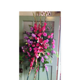 Tall pink and purple floral standing spray on an easel