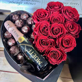 Heart-shaped box with red roses, chocolates, and a mini Moet bottle