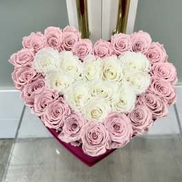 Heart-shaped box of pink and white roses