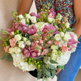 Bouquet of pink and white flowers with green berries and eucalyptus