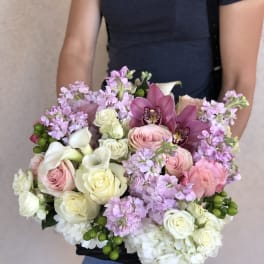 Handheld bouquet of pink and white roses with purple orchids and calla lilies