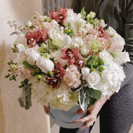Large bouquet of white and pink flowers in a blue box