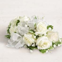 White rose bouquet with baby's breath and a sheer ribbon bow