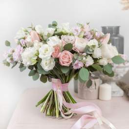 Bouquet of blush and white roses with pink ribbon