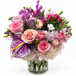 Pink and purple mixed bouquet in a clear glass vase