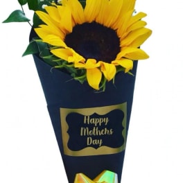Sunflower bouquet in dark wrap with a Happy Mothers Day label