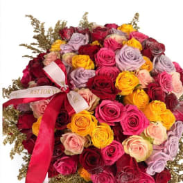 Large bouquet of multicolored roses with a red ribbon bow