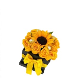 Yellow sunflower and roses in a black box with a yellow ribbon