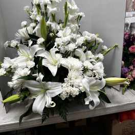 White lilies and chrysanthemums in a large floral arrangement